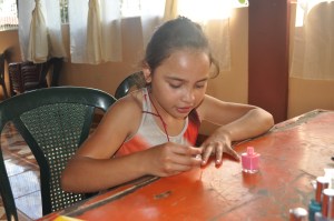 Cristi painting her nails.